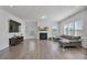 Spacious living room with a fireplace, large windows, and a comfortable sectional sofa at 1305 Addison Lake St, Fuquay Varina, NC 27526