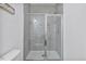 Modern tiled shower featuring clear glass doors, bright lighting, and a clean design at 1305 Addison Lake St, Fuquay Varina, NC 27526