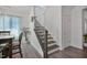 Welcoming staircase with hardwood steps and an elegant iron railing at 1305 Addison Lake St, Fuquay Varina, NC 27526