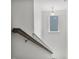 Stairwell with carpeted stairs, wooden banister, and window at 1305 Addison Lake St, Fuquay Varina, NC 27526