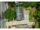 Aerial view of a well maintained property featuring ample parking space, lush greenery and mature trees at 1313 Ridge Rd, Raleigh, NC 27607
