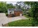 Back exterior of a brick home with a well-maintained lawn and driveway at 1313 Ridge Rd, Raleigh, NC 27607