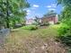 Expansive backyard featuring a lush lawn, mature trees, and lovely landscaping at 1313 Ridge Rd, Raleigh, NC 27607