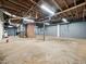 The expansive basement has exposed beams and a large open area for storage at 1313 Ridge Rd, Raleigh, NC 27607