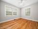 The bedroom has hardwood floors, neutral paint, and abundant natural light at 1313 Ridge Rd, Raleigh, NC 27607