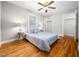 Serene bedroom with hardwood floors, a ceiling fan, and ample natural light for relaxation at 1313 Ridge Rd, Raleigh, NC 27607