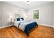 Cozy bedroom with hardwood floors, complemented by plentiful natural light at 1313 Ridge Rd, Raleigh, NC 27607