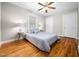 Comfortable bedroom featuring hardwood floors, a ceiling fan, and natural light from a window at 1313 Ridge Rd, Raleigh, NC 27607