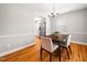 Charming dining room features hardwood floors, neutral paint, and updated lighting fixture at 1313 Ridge Rd, Raleigh, NC 27607