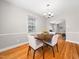 Inviting dining room boasts hardwood floors, neutral walls, and an updated light fixture at 1313 Ridge Rd, Raleigh, NC 27607