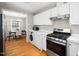 Open kitchen showcasing stainless appliances and an adjacent dining area that is perfect for entertaining at 1313 Ridge Rd, Raleigh, NC 27607