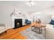 An open-concept living room with hardwood floors, a fireplace, and a view of the dining area at 1313 Ridge Rd, Raleigh, NC 27607