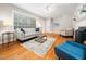 Bright living room features hardwood floors, a window with blinds, and a neutral color palette at 1313 Ridge Rd, Raleigh, NC 27607