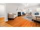A bright living room with hardwood floors, a fireplace, and lots of natural light at 1313 Ridge Rd, Raleigh, NC 27607