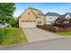 Rear exterior featuring a two-car garage and spacious driveway, enclosed by a decorative wooden fence at 1328 Palace Garden Way, Raleigh, NC 27603
