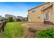 Expansive backyard with lush green lawn, a stone patio, and surrounded by well-maintained landscaping at 1328 Palace Garden Way, Raleigh, NC 27603