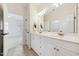 Bright bathroom boasts double sink vanity, large mirror and modern fixtures at 1328 Palace Garden Way, Raleigh, NC 27603