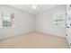 Bright bedroom features neutral carpet and natural light from two windows at 1328 Palace Garden Way, Raleigh, NC 27603