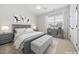 Charming bedroom featuring a neutral palette, plush carpet, and ample natural light streaming through the window at 1328 Palace Garden Way, Raleigh, NC 27603