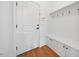 Welcoming entryway featuring a white front door, coat rack, and built-in storage bench with white cabinets at 1328 Palace Garden Way, Raleigh, NC 27603