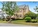 Two-story home with manicured landscaping, colorful bushes, and a mature shade tree in the front yard at 1328 Palace Garden Way, Raleigh, NC 27603