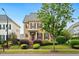 Charming two-story home featuring a well-manicured lawn, mature landscaping, and a welcoming front porch at 1328 Palace Garden Way, Raleigh, NC 27603
