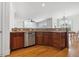 Well-lit kitchen featuring wood cabinets, granite countertops and a stainless steel dishwasher at 1328 Palace Garden Way, Raleigh, NC 27603