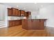 Charming kitchen features wooden cabinets, granite counters, and a cozy layout, perfect for culinary enthusiasts at 1328 Palace Garden Way, Raleigh, NC 27603