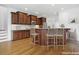 Kitchen with brown cabinets, tiled backsplash, and breakfast bar with seating at 1328 Palace Garden Way, Raleigh, NC 27603