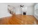 Cozy living room features hardwood floors, a fireplace, and staircase, creating a warm and inviting space at 1328 Palace Garden Way, Raleigh, NC 27603
