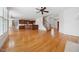 Open-concept living room with hardwood floors, flowing into a kitchen area, perfect for modern living and entertaining at 1328 Palace Garden Way, Raleigh, NC 27603