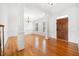 Elegant living room with hardwood floors, decorative columns, and large windows that provide plenty of natural light at 1328 Palace Garden Way, Raleigh, NC 27603
