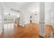 Bright living room with hardwood floors, white columns, and staircase, offering a spacious and inviting atmosphere at 1328 Palace Garden Way, Raleigh, NC 27603