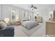 Spacious main bedroom featuring a ceiling fan, windows with curtains, and a comfortable bed on a rug at 1328 Palace Garden Way, Raleigh, NC 27603