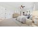 Bright main bedroom with ceiling fan, walk-in closet, and two chairs under an attractive beach scene at 1328 Palace Garden Way, Raleigh, NC 27603