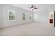 Bright and spacious main bedroom with plush carpet, abundant natural light, and ceiling fan providing a relaxing retreat at 1328 Palace Garden Way, Raleigh, NC 27603