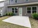 Back of home featuring neutral siding, windows, door and a concrete patio at 1380 Channing Park Cir, Cary, NC 27519
