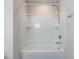 Clean, white bathtub with shower and storage shelves in a well-lit bathroom at 1380 Channing Park Cir, Cary, NC 27519