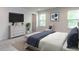 A well-lit bedroom with a TV, dresser, and neutral decor for a cozy and inviting space at 1380 Channing Park Cir, Cary, NC 27519