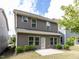 Back of home featuring neutral siding, windows, and a small patio area at 1380 Channing Park Cir, Cary, NC 27519