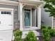 Close-up view of the inviting front door with sidelights and decorative stone accents at 1380 Channing Park Cir, Cary, NC 27519