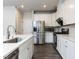 Stylish kitchen with stainless steel appliances, white cabinetry, and a functional layout at 1380 Channing Park Cir, Cary, NC 27519