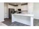 Modern kitchen featuring white cabinets, stainless steel appliances, and a center island at 1380 Channing Park Cir, Cary, NC 27519