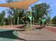 Community playground featuring modern play structures, swings, and soft rubber flooring at 1380 Channing Park Cir, Cary, NC 27519