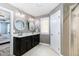 Modern bathroom with double vanity, framed mirrors, neutral walls, and tile flooring at 1424 Forest Fern Ln, Fuquay Varina, NC 27526