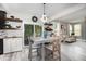 Dining room features a table for four, custom shelving, and access to the living space and back patio at 1424 Forest Fern Ln, Fuquay Varina, NC 27526
