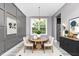 Chic dining room with modern furnishings, elegant lighting, decorative wall art, and adjacent kitchen access at 1424 Forest Fern Ln, Fuquay Varina, NC 27526