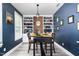 Charming dining room featuring built-in bookshelves, dark blue walls, and an inviting atmosphere at 1424 Forest Fern Ln, Fuquay Varina, NC 27526