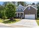 Charming two-story home with brick and siding, a well-manicured lawn, and a two-car garage at 1424 Forest Fern Ln, Fuquay Varina, NC 27526