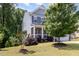 Well-maintained two-story home with beautiful landscaping and a welcoming front porch at 1424 Forest Fern Ln, Fuquay Varina, NC 27526